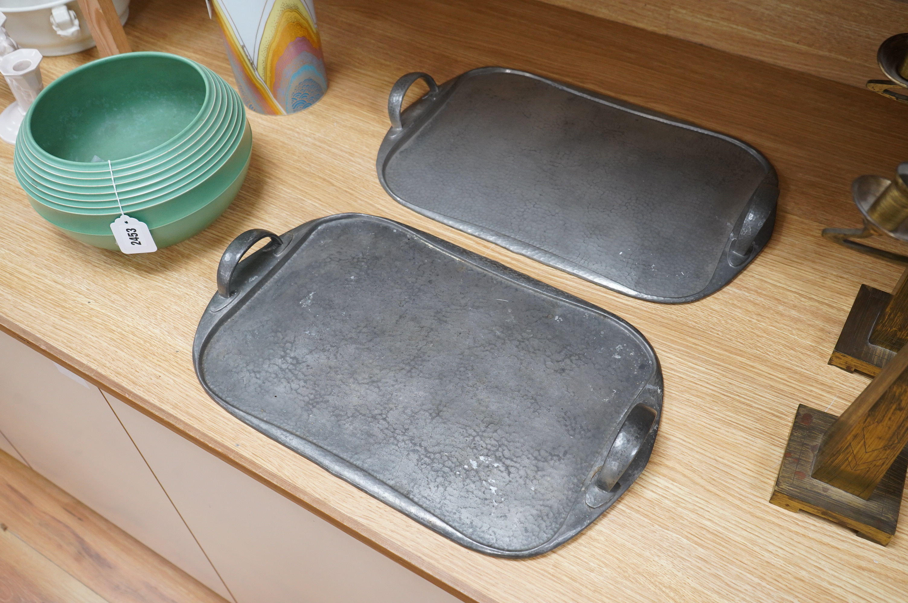 Archibald Knox for Liberty, two pewter Arts and Crafts Tudric trays, each numbered 043, 46cm wide